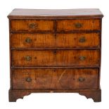 A George II walnut and crossbanded chest of drawers, circa 1735,