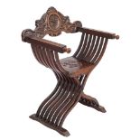 An Italian carved walnut Savanarola elbow chair,