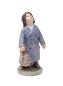 A Royal Copenhagen porcelain figure of a boy modelled by Ada Bonfils with a satchel and holding an