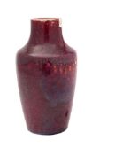 A Ruskin high-fired vase covered in a mottled flambé and lavender glaze,