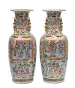 A pair of Chinese Canton famille rose baluster vases applied with gilt chilong and lion dog handles,