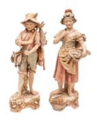 A pair of Royal Dux figures of child street vendors,