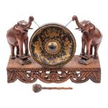 An Anglo-Burmese carved and stained hardwood and metal mounted dinner or hall gong,