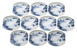 A set of ten Japanese blue and white shaped dishes each painted with a lake landscape with a figure