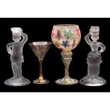 Two enamelled wine glasses together with a pair of frosted figural candlesticks, tallest glass 25cm.