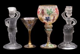 Two enamelled wine glasses together with a pair of frosted figural candlesticks, tallest glass 25cm.