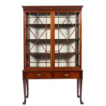 A mahogany glazed display cabinet on stand in George II taste,