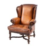 A leather upholstered wing armchair in Queen Anne/ early George I taste,