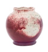 A Ruskin high-fired bowl of globular form with shaped rim, covered in a flambé,