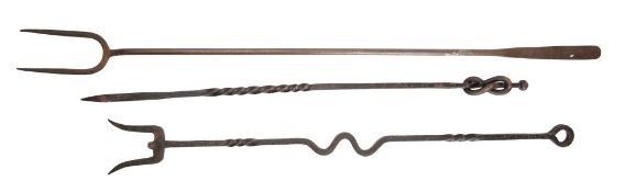 Two late 19th century wrought iron log forks together with a wrought iron poker with spiral twist
