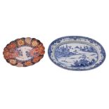 A Chinese blue and white oval meat dish painted with an extensive lake scene with pagodas and