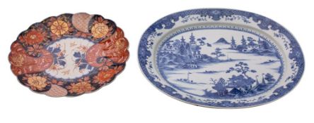 A Chinese blue and white oval meat dish painted with an extensive lake scene with pagodas and