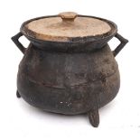 A bronze twin-handled cauldron of traditional bag shape with angular handles,