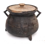 A bronze twin-handled cauldron of traditional bag shape with angular handles,