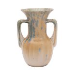 A Ruskin two-handled vase with flared rim, covered in a pale yellow,