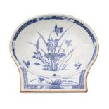 A Chinese blue and white shell-shaped dish painted with lotus within a diaper border, Qianlong,