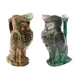 Two majolica ewers both modelled in the form of owls with flowering branch handles under green,