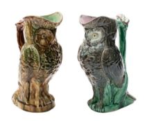 Two majolica ewers both modelled in the form of owls with flowering branch handles under green,