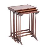 A nest of three mahogany occasional tables in Regency style,