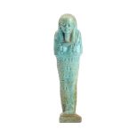 An Egyptian turquoise-glazed faience shabti in mummiform pose with seven rows of hieroglyphs,