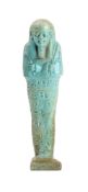 An Egyptian turquoise-glazed faience shabti in mummiform pose with seven rows of hieroglyphs,