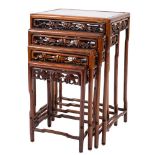 A nest of four Chinese hardwood occasional tables, 20th century; of rectangular form,
