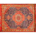 A Turkoman Rug, the brick red field with a central ivory and indigo geometric medallion,