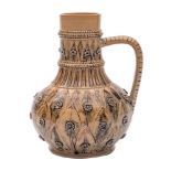 A Doulton Lambeth stoneware ewer incised with bands of stiff leaves and applied flower heads under