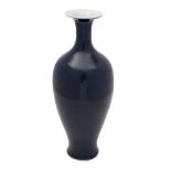 A Chinese blue monochrome vase of baluster form with slender neck and flared neck,