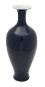 A Chinese blue monochrome vase of baluster form with slender neck and flared neck,