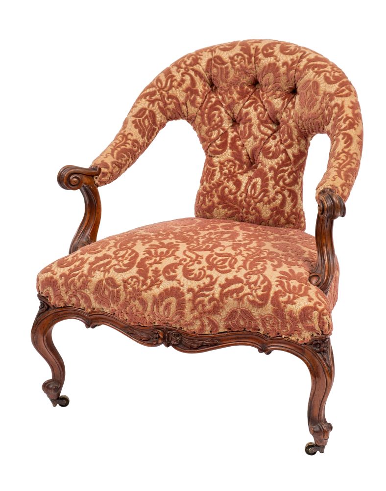 A Victorian carved walnut and button upholstered salon chair,