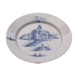An English blue and white delftware dish painted with a fisherman on a bridge,