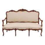 A suite of carved walnut and cream fabric upholstered salon furniture in Louis XV style,