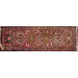 A Hamadan Runner, the rose field with a row of geometric medallions,