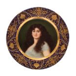 A Vienna cabinet plate painted with a head and shoulders portrait of a female beauty within an