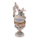 A German porcelain ewer in Capodimonte style relief moulded with mythical figures,