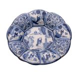 A Dutch delftware blue and white lobed dish painted in Chinese Kraak style with panels of flowers