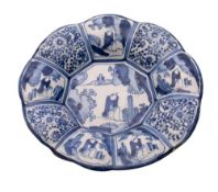 A Dutch delftware blue and white lobed dish painted in Chinese Kraak style with panels of flowers