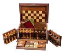 An early 20th century mahogany games compendium fitted with folding games board,