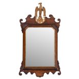 A walnut and parcel gilt framed wall mirror in George I taste,