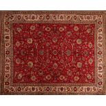 A Tabriz Carpet, the wine field with an all over design of palmettes and scrolling floral foliage,
