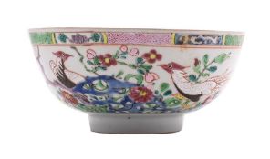 A Chinese famille rose porcelain bowl, enamelled with a pair of pheasants amongst pierced rocks,