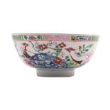 A Chinese famille rose porcelain bowl, enamelled with a pair of pheasants amongst pierced rocks,