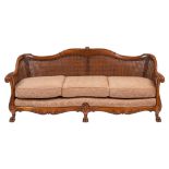A carved walnut and canework Bergere suite,