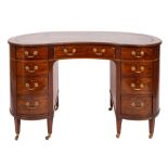 A mahogany, crossbanded and line inlaid kidney shaped desk in George III style,