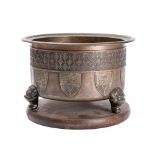 A Chinese bronze jardiniere of circular outline with banded trellis decoration with suspended