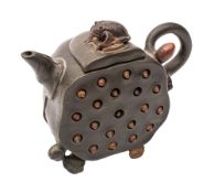 A Chinese Yixing stoneware tea pot of green hue with brown highlights modelled in the form of a