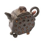 A Chinese Yixing stoneware tea pot of green hue with brown highlights modelled in the form of a