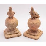 A pair of late 19th/early 20th century terracotta roof finials in the form of a dove resting on a