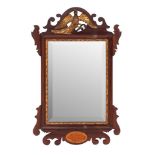 An Edwardian mahogany and parcel gilt framed wall mirror in George I taste; early 20th century;